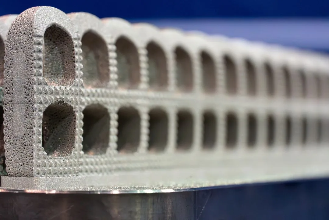 Close up of titanium powder being fused layer by layer on the build plate